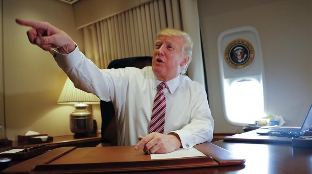 President Donald Trump points towards members of the media while seated at his desk on Air Force One upon his arrival at Andrews Air Force Base Md Thursday Jan 26 2017 AP Photo Pablo Martinez Monsivais