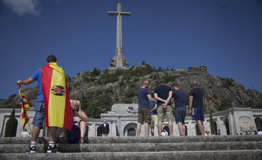 Un hombre porta una bandera preconstitucional en el Valle de los Caídos. (EL PAÍS)